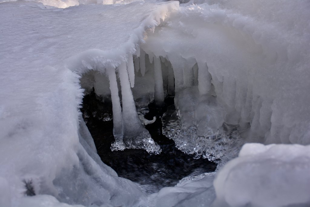 A photo of icicles forming over a body of water
